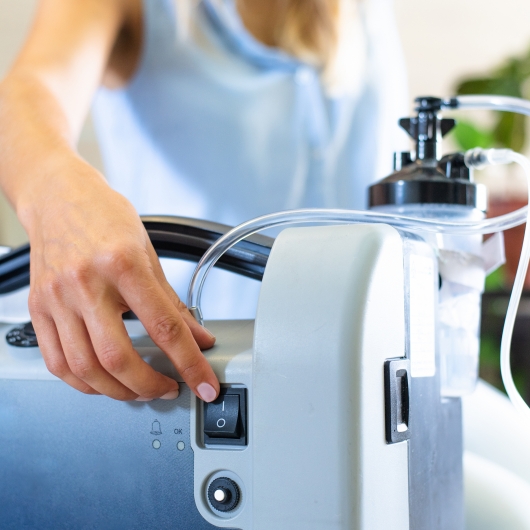 Woman uses oxygen concentrator